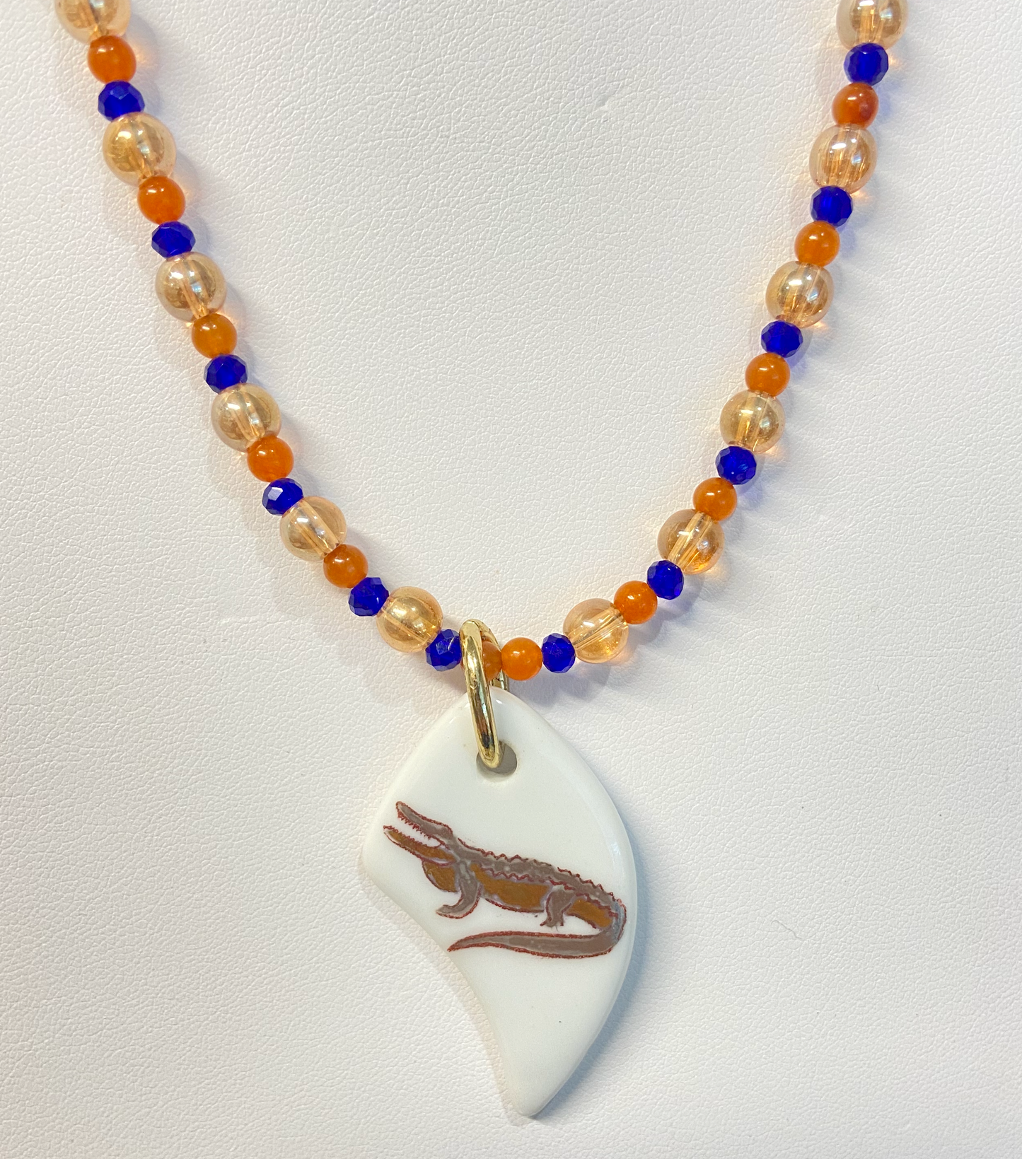 Gator Necklace hand painted gator in gold and platinum on a porcelain pendant