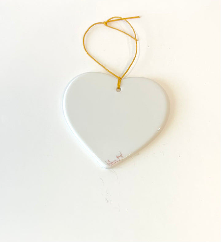 White porcelain heart ornament 3.25" with the wording joy and a manger scene