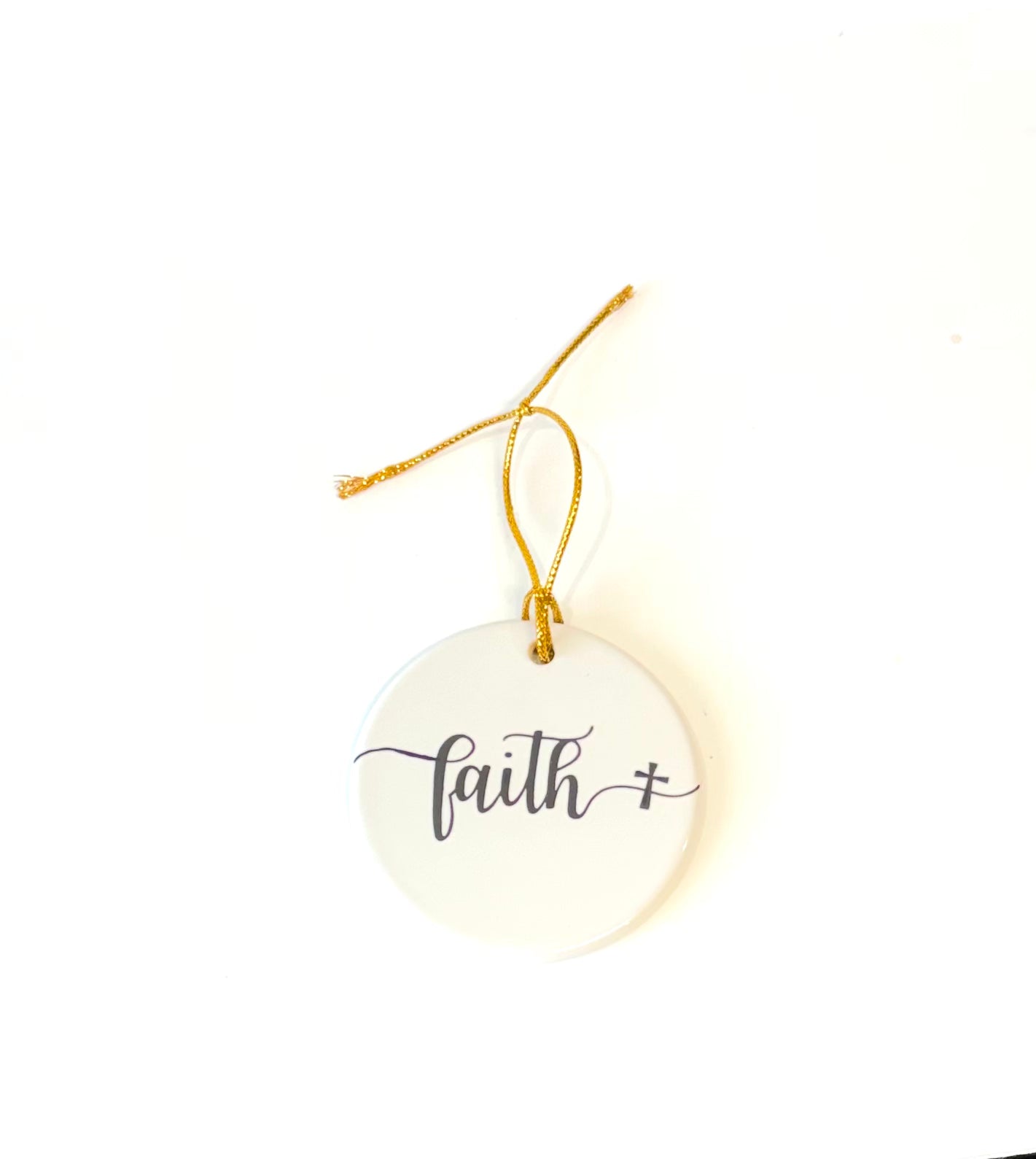 White porcelain round ornament with the wording faith
