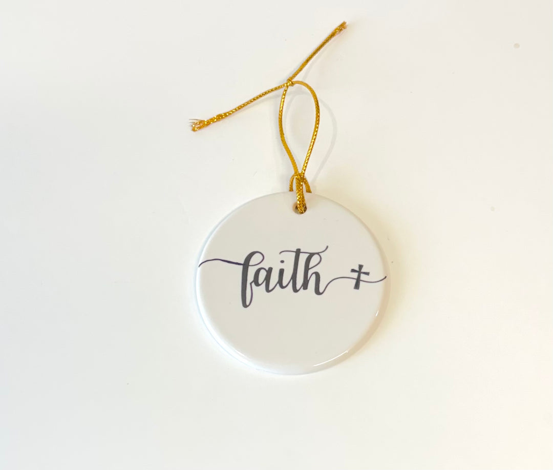 White porcelain round ornament with the wording faith