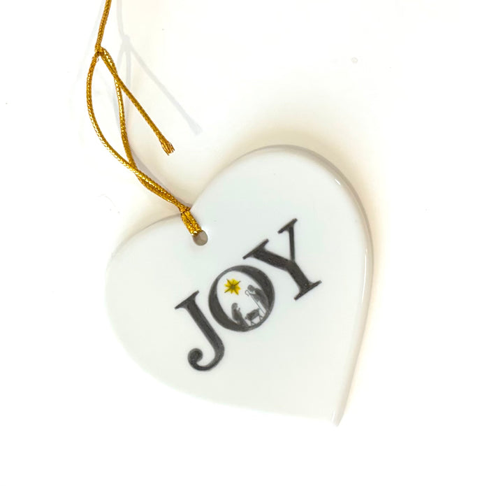 White porcelain heart ornament 3.25" with the wording joy and a manger scene