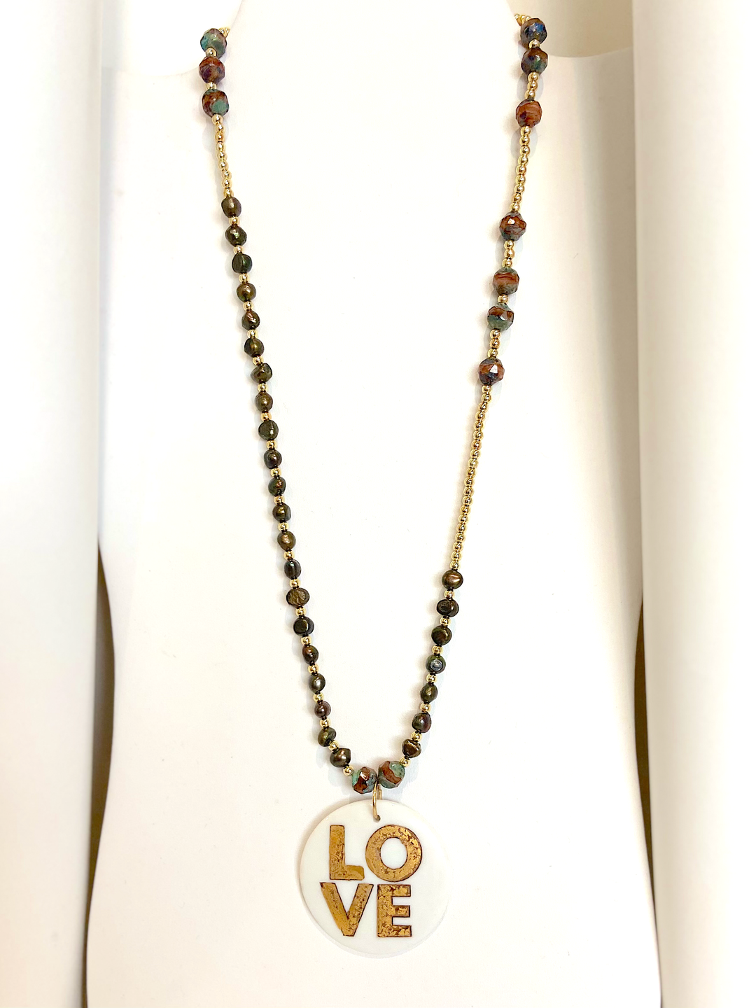 Love pendant on beaded necklace