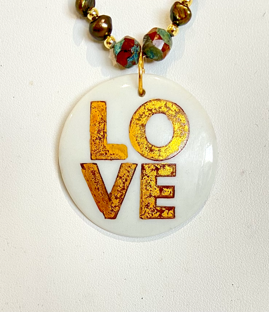 Love pendant on beaded necklace